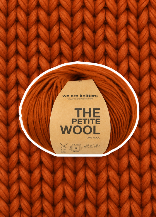 Petite Wool Cinnamon yarn ball on a matching knit swatch