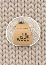 Petite Wool Spotted Beige yarn ball on a matching knit swatch