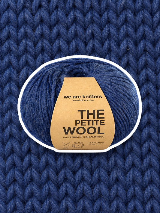 Petite Wool Spotted Blue yarn ball on a matching knit swatch