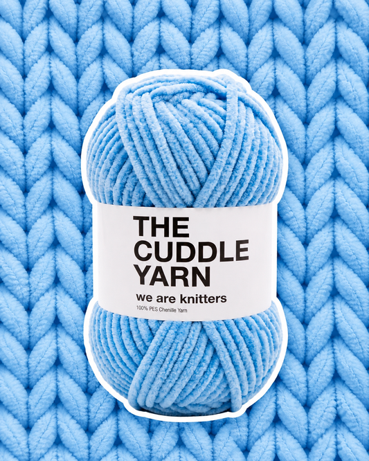 The Cuddle Yarn Blue chenille skein on a matching knit swatch