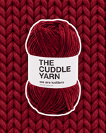 The Cuddle Yarn Red chenille skein on a matching knit swatch