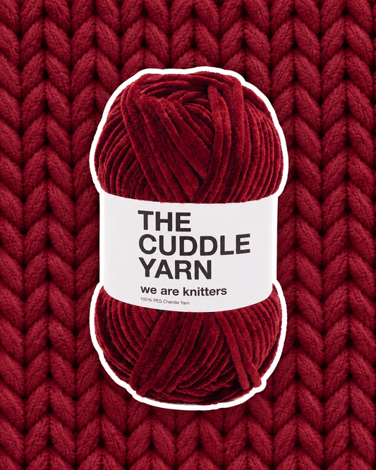 The Cuddle Yarn Red chenille skein on a matching knit swatch