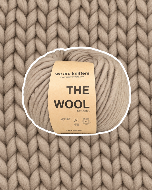 The Wool Taupe yarn ball on a matching knit swatch