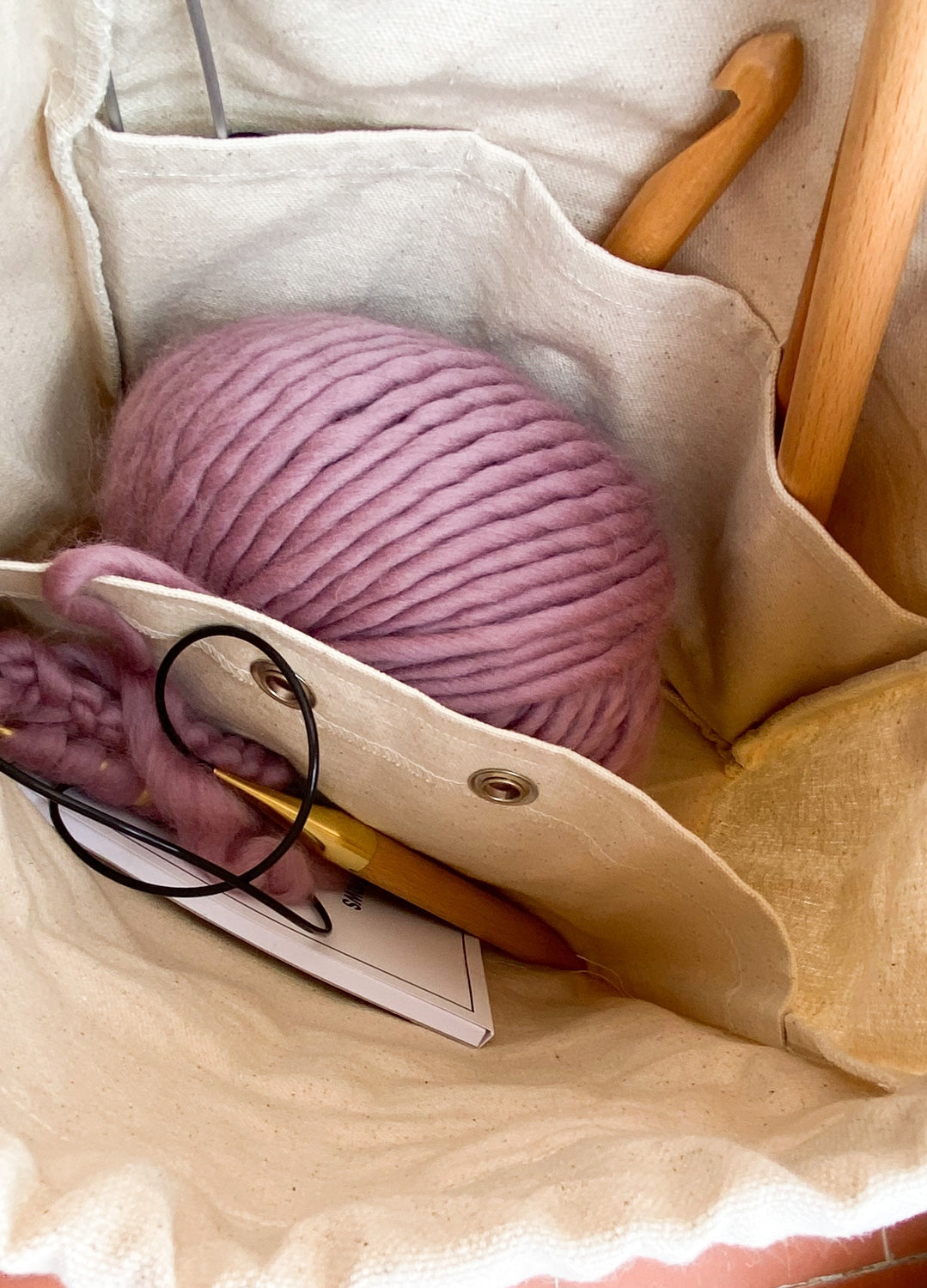 Inside the #WIP Bag - room for a full ball of yarn, circular and straight needles, and the pattern booklet